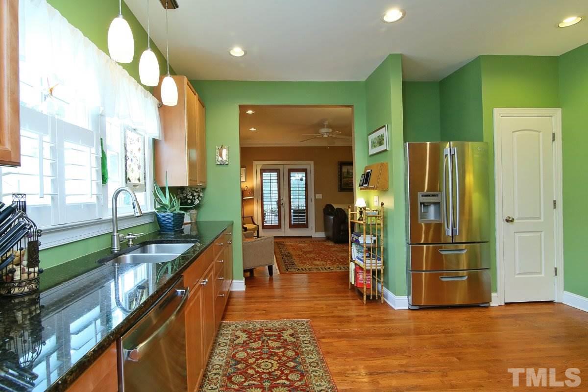 212 Georgetown Road Raleigh, NC 27608 - Photo 10 of 24 a view of a hallway with wooden floor and staircase
