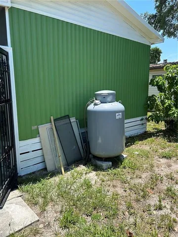 a roof deck with table and chairs under an umbrella with large trees