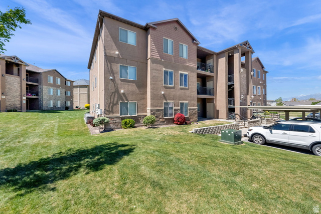 8215 Clear Rock Road, Unit 12 Eagle Mountain, UT 84005 - Photo 31 of 38 Multi-story residential building with stucco and stone veneer exterior