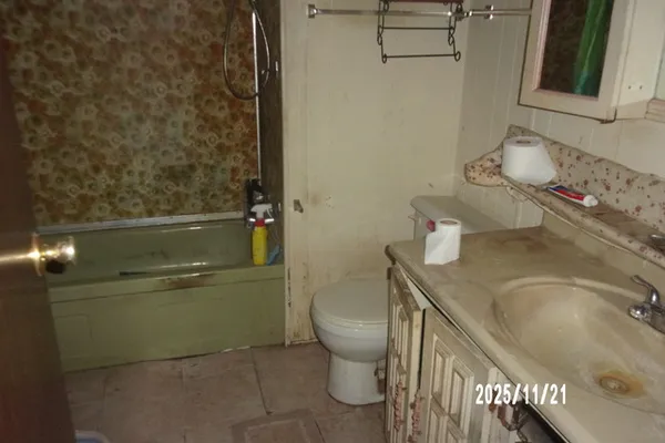 a bathroom with a granite countertop sink a toilet and a mirror