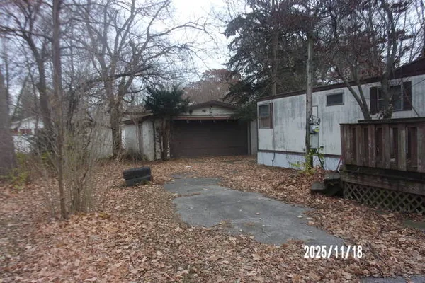 a view of a house with a yard covered in snow