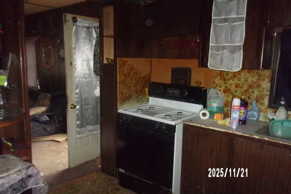 a kitchen with a refrigerator and a stove