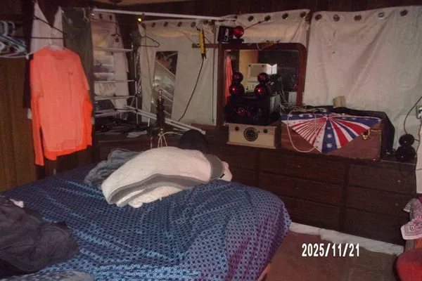 a bed room with a bed and a mirror