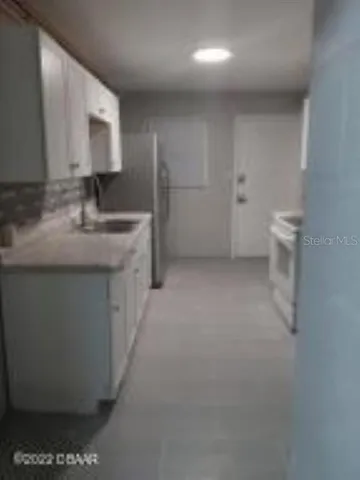a kitchen with a sink and a toilet