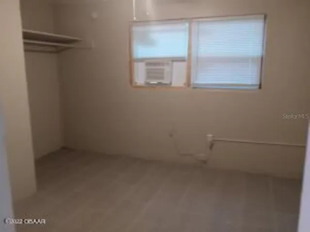 a view of an empty room with a window