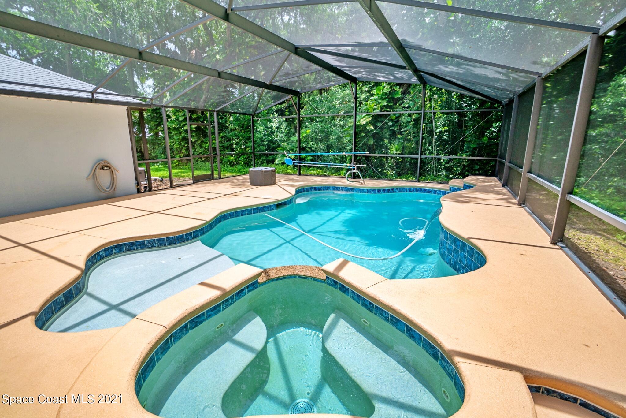 7250 Camilo Road Cocoa, FL 32927 - Photo 2 of 45 a view of a backyard with a small deck and a garden