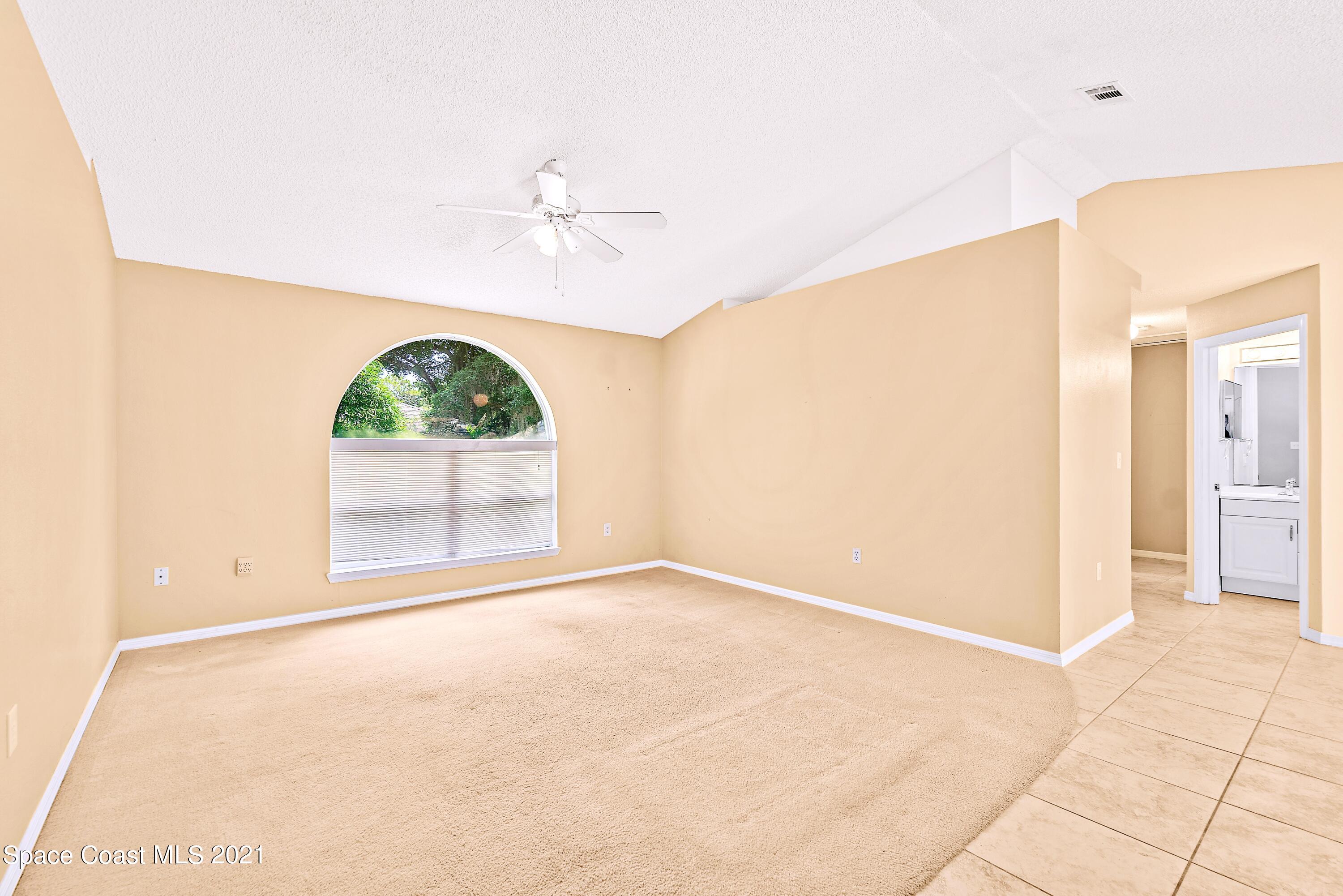 7250 Camilo Road Cocoa, FL 32927 - Photo 12 of 45 an empty room with windows and ceiling fan