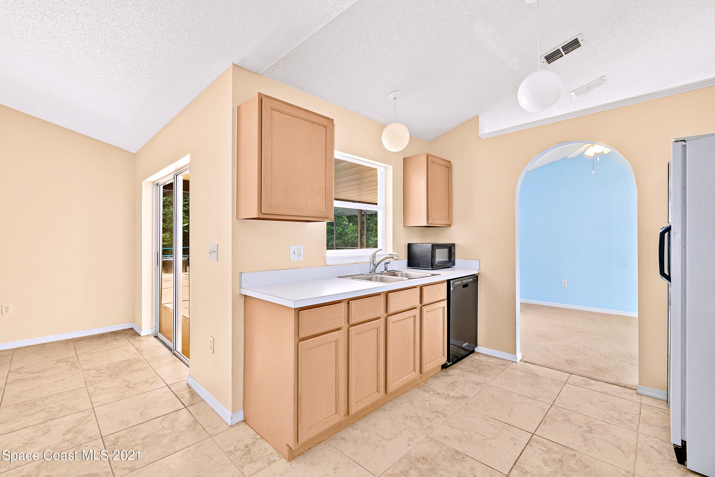 7250 Camilo Road Cocoa, FL 32927 - Photo 17 of 45 a kitchen with a sink stove and refrigerator