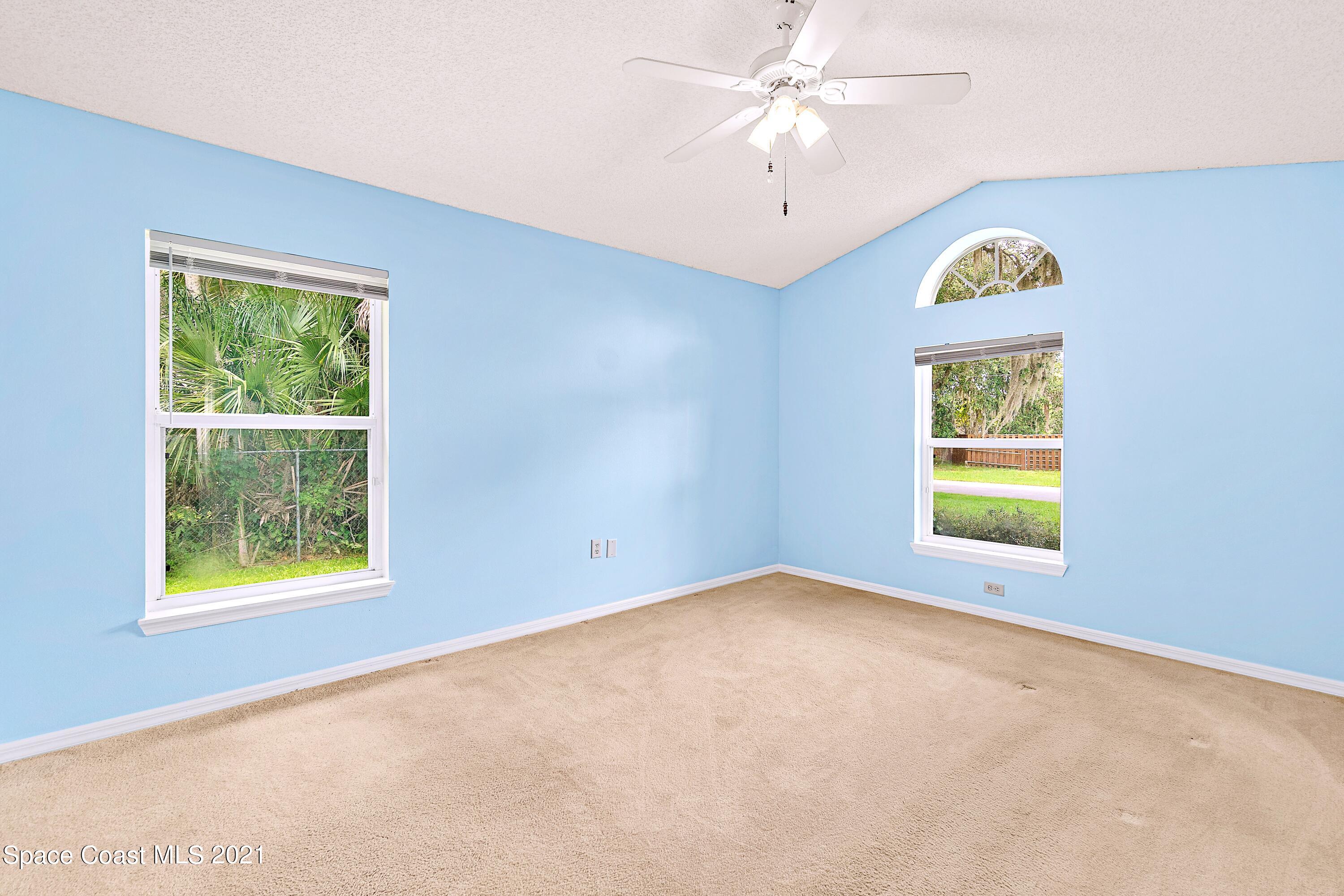 7250 Camilo Road Cocoa, FL 32927 - Photo 22 of 45 an empty room with windows and fan