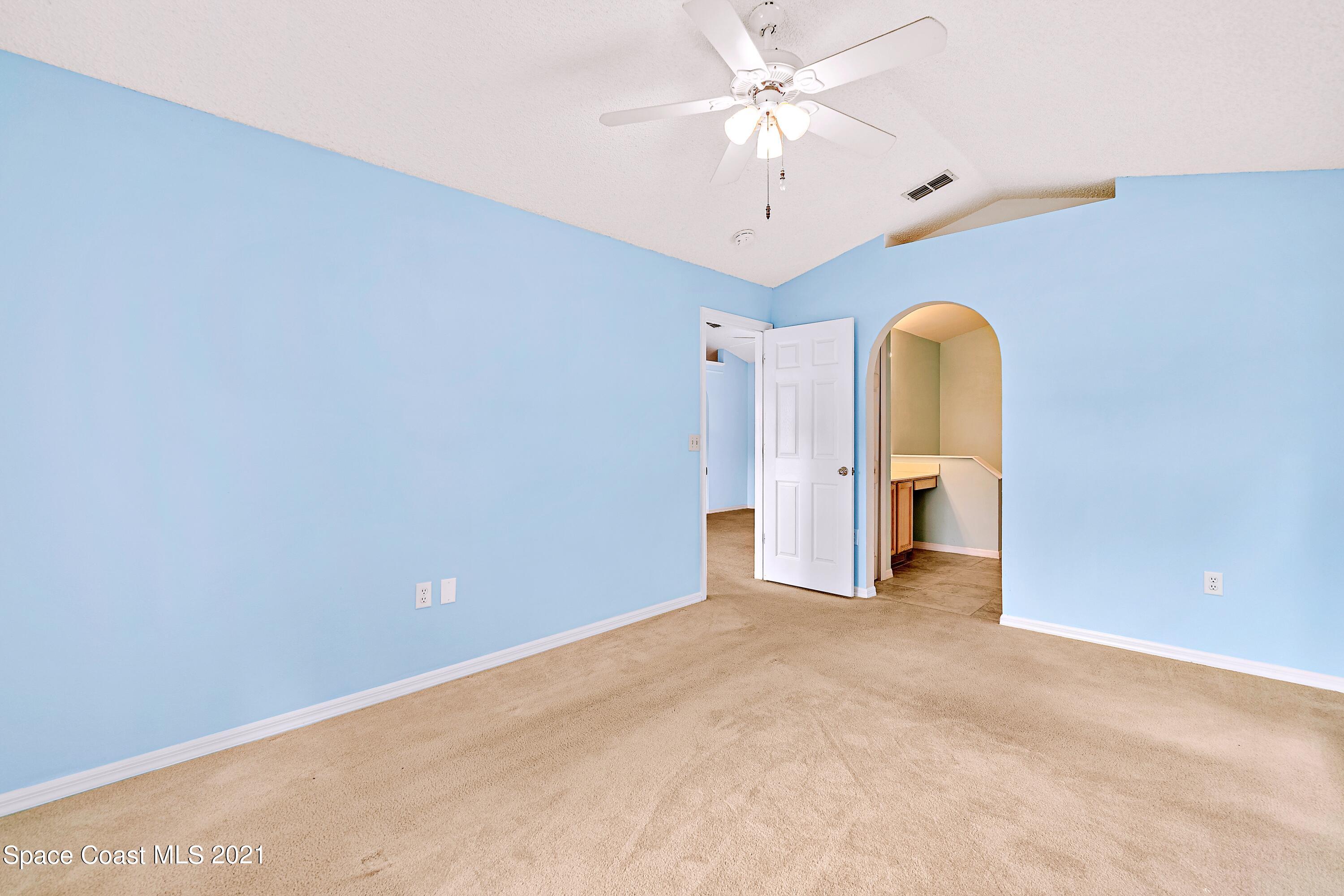 7250 Camilo Road Cocoa, FL 32927 - Photo 23 of 45 an empty room with a ceiling fan and window