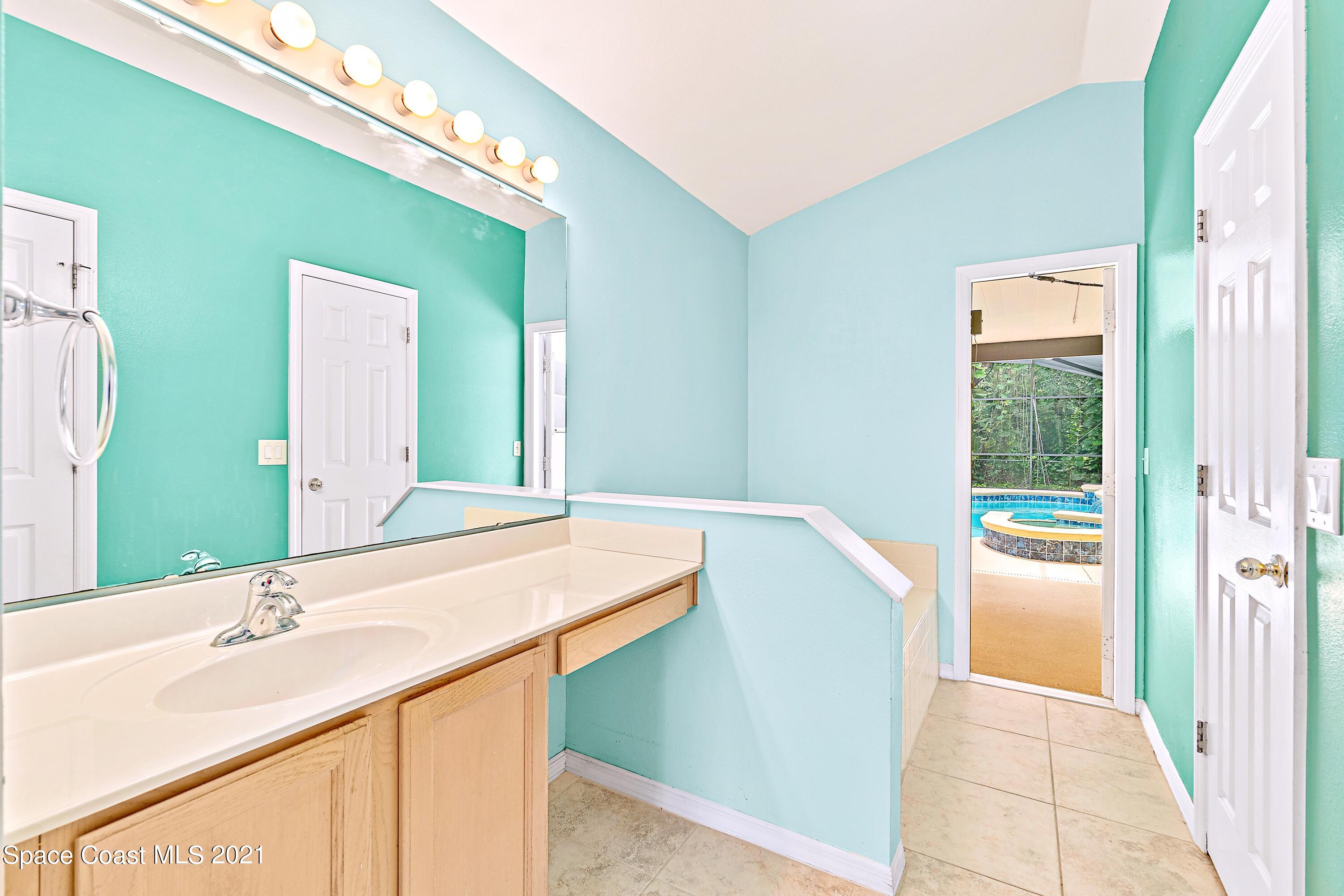 7250 Camilo Road Cocoa, FL 32927 - Photo 24 of 45 a bathroom with a granite countertop sink and a mirror