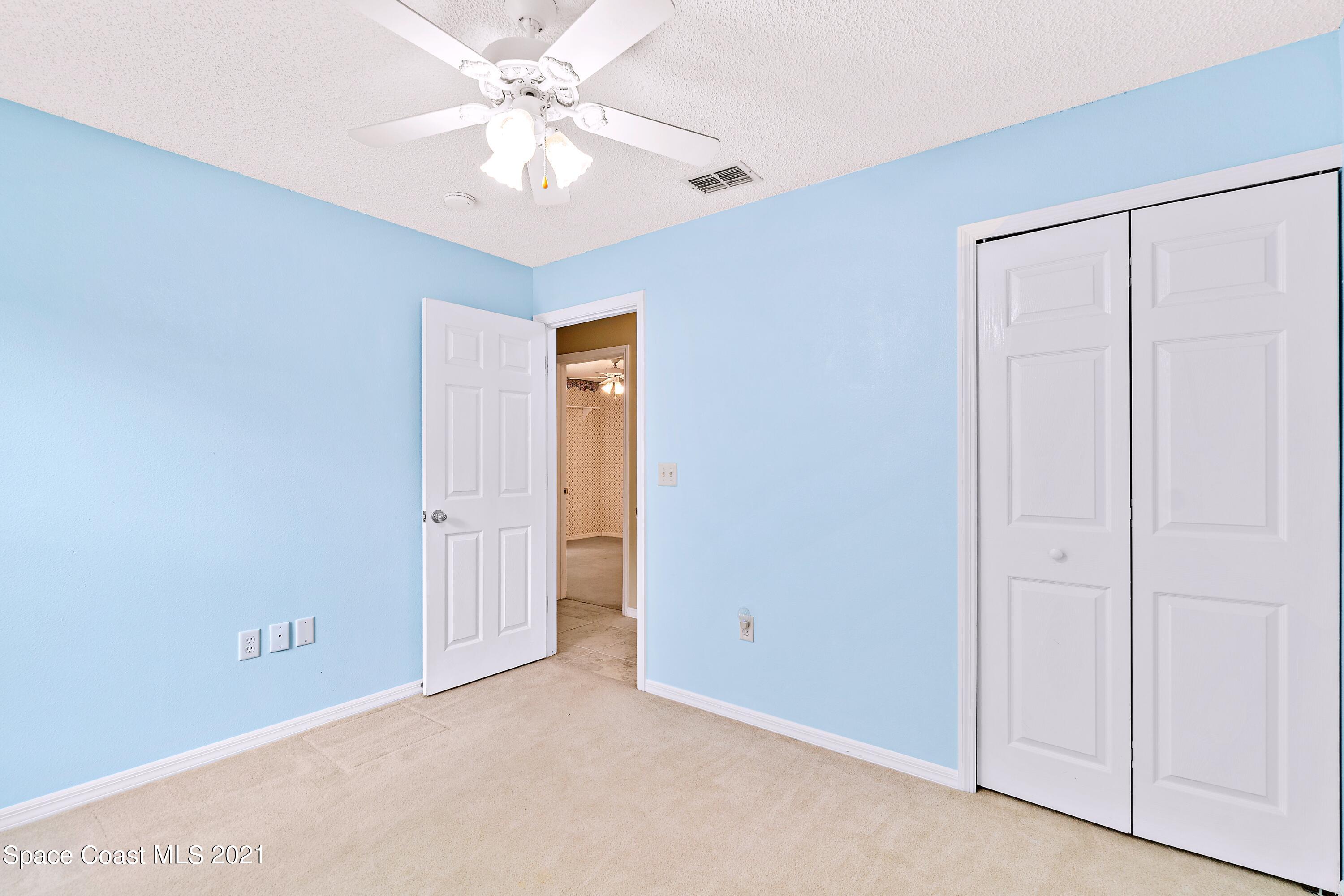 7250 Camilo Road Cocoa, FL 32927 - Photo 27 of 45 an empty room with a ceiling fan and a window