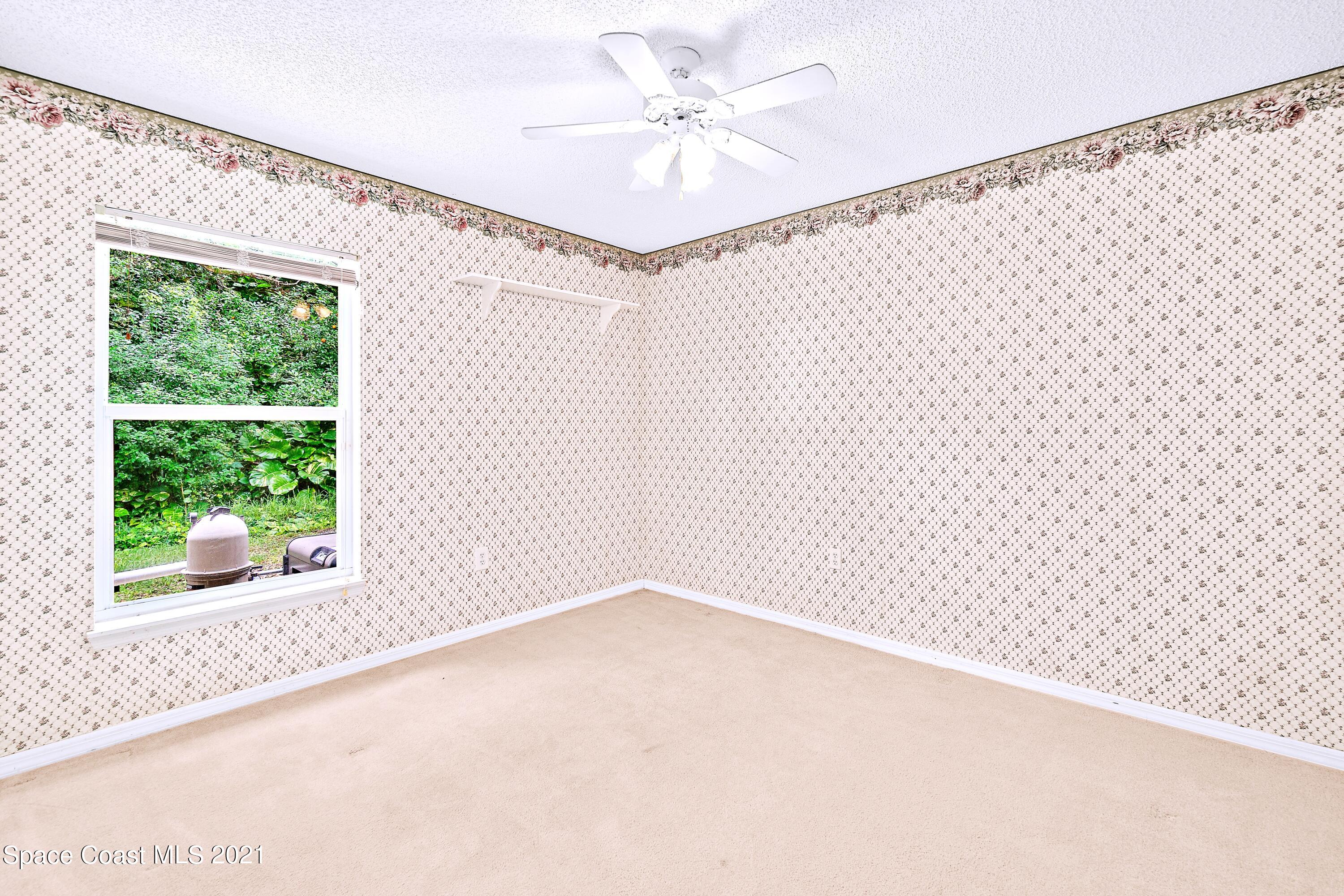 7250 Camilo Road Cocoa, FL 32927 - Photo 30 of 45 a view of a room with a window and a ceiling fan