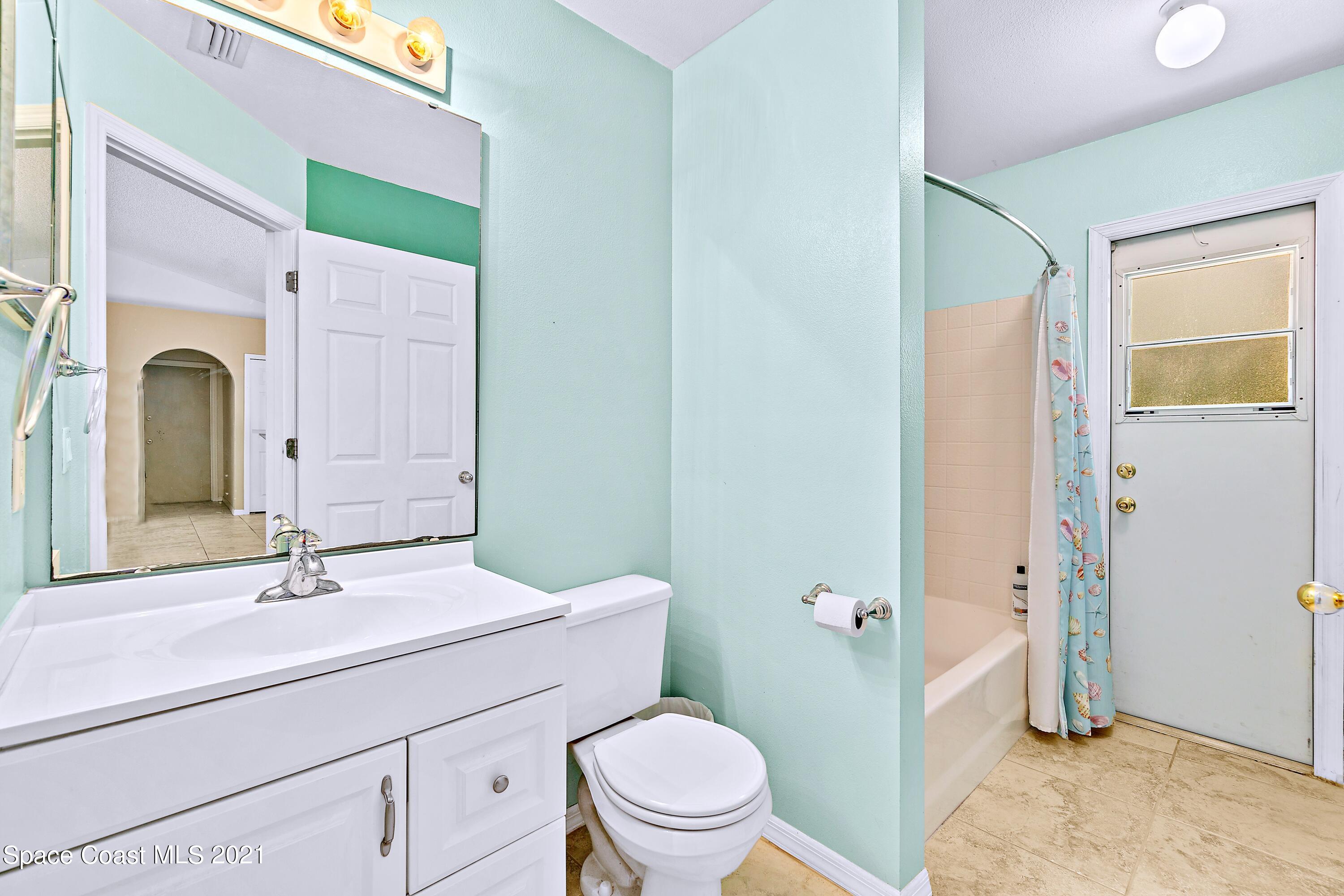 7250 Camilo Road Cocoa, FL 32927 - Photo 32 of 45 a bathroom with a toilet a sink and a mirror