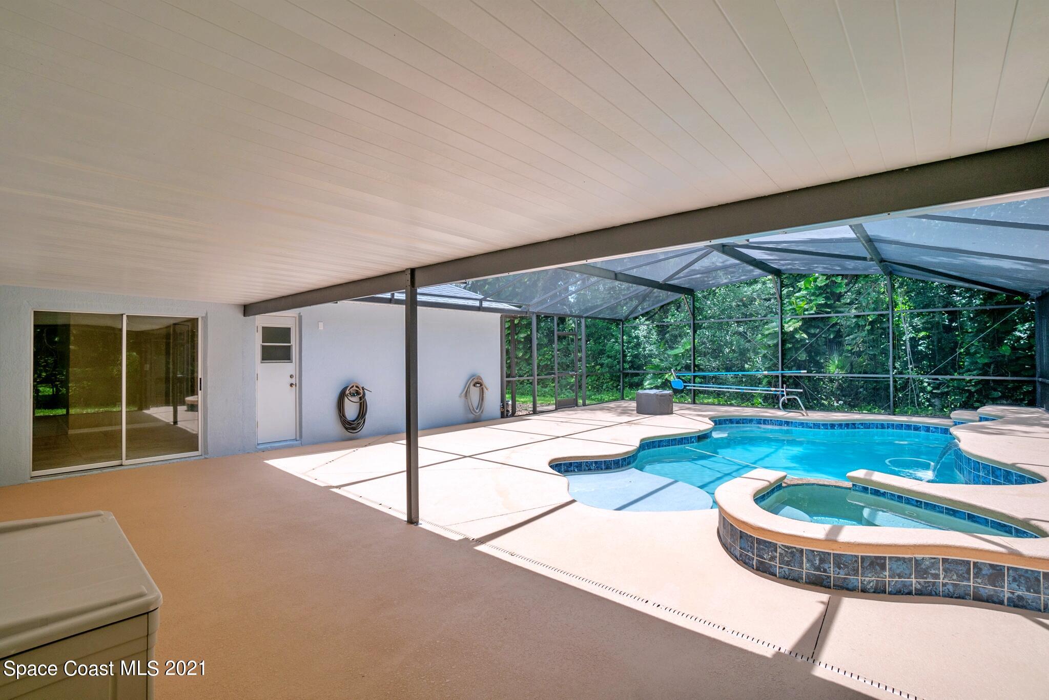 7250 Camilo Road Cocoa, FL 32927 - Photo 36 of 45 a swimming pool with outdoor seating and yard
