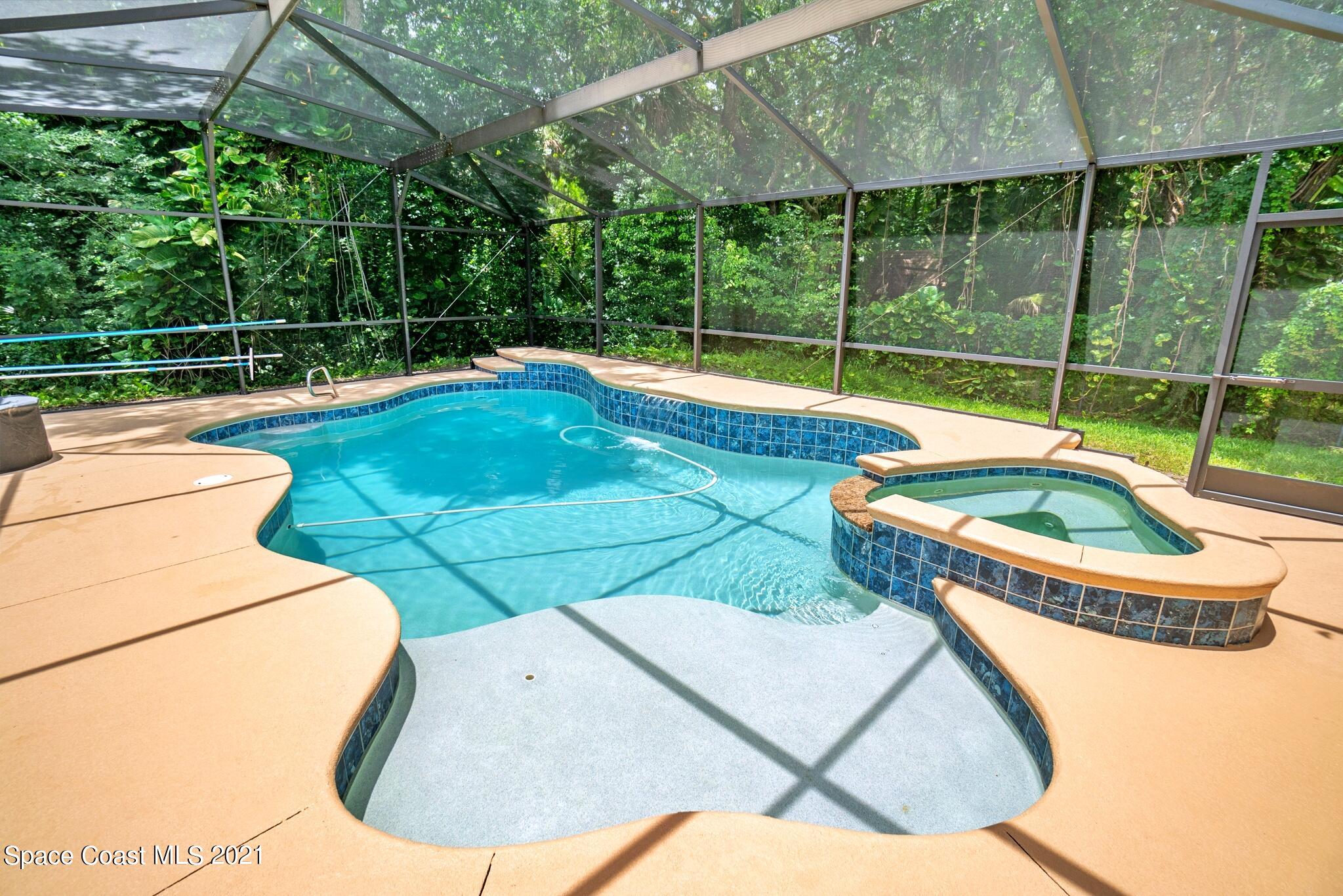 7250 Camilo Road Cocoa, FL 32927 - Photo 38 of 45 a view of a swimming pool with a yard and sitting area