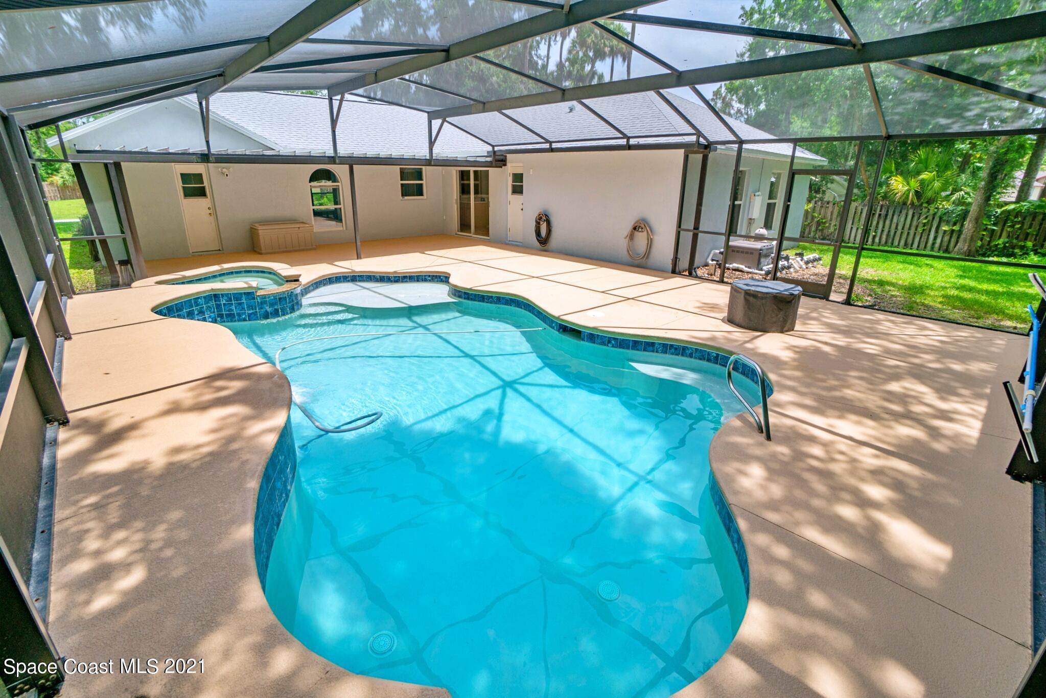 7250 Camilo Road Cocoa, FL 32927 - Photo 40 of 45 a view of a swimming pool with a patio and yard