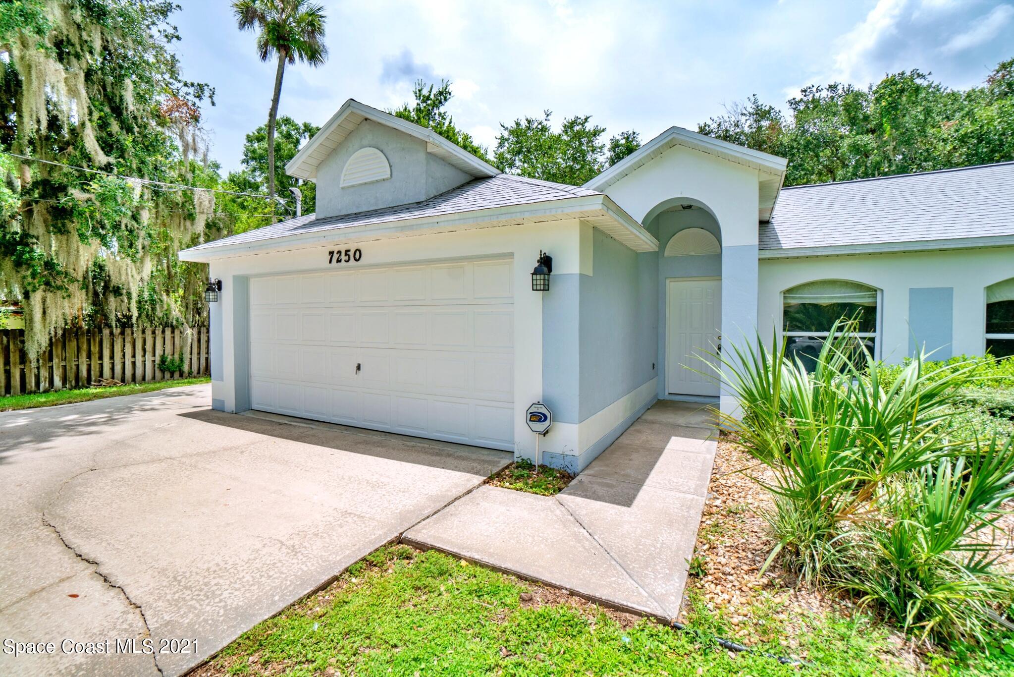 7250 Camilo Road Cocoa, FL 32927 - Photo 5 of 45 a front view of a house with garden