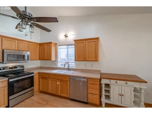 a kitchen with a sink appliances and cabinets