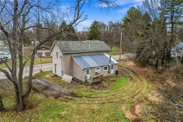 a house that has a tree in front of it