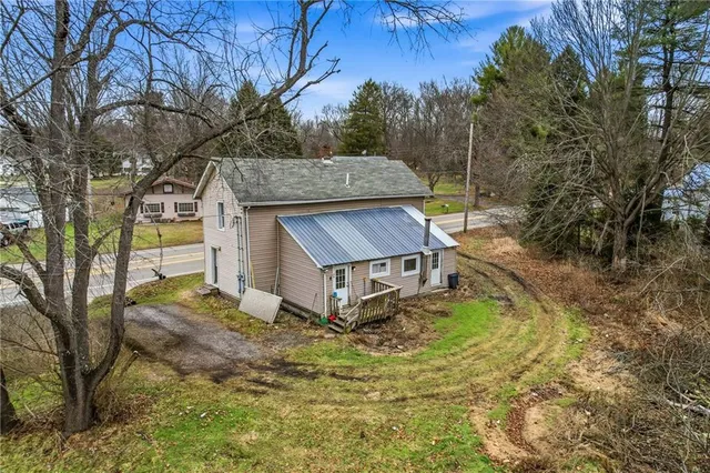 a house that has a tree in front of it