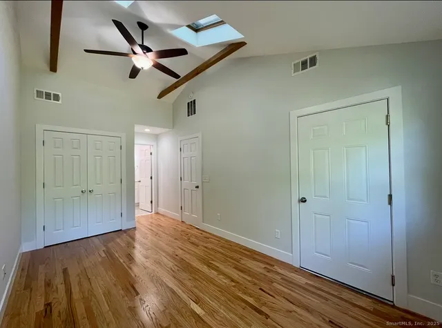 a view of room with wooden floor