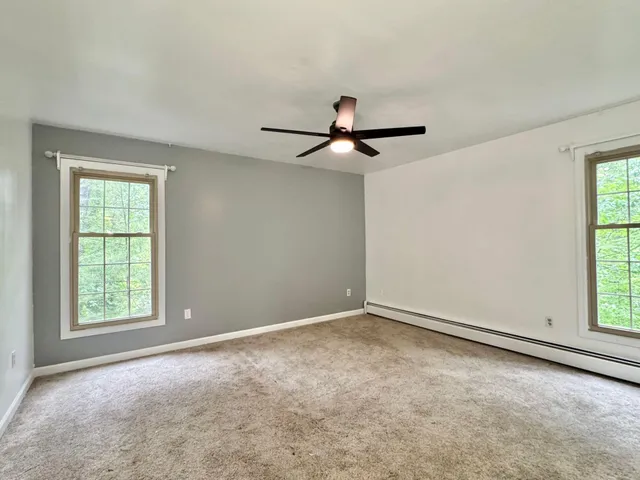 a view of a livingroom with a large window and an empty room