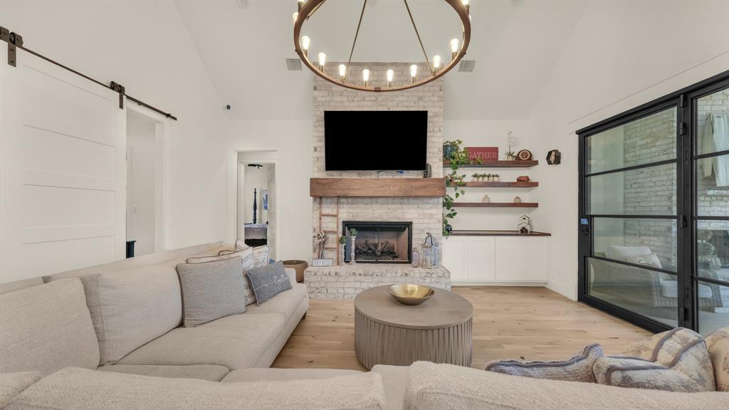 374 Glade Valley Road Azle, TX 76020 - Photo 13 of 38 a living room with furniture a flat screen tv and a fireplace