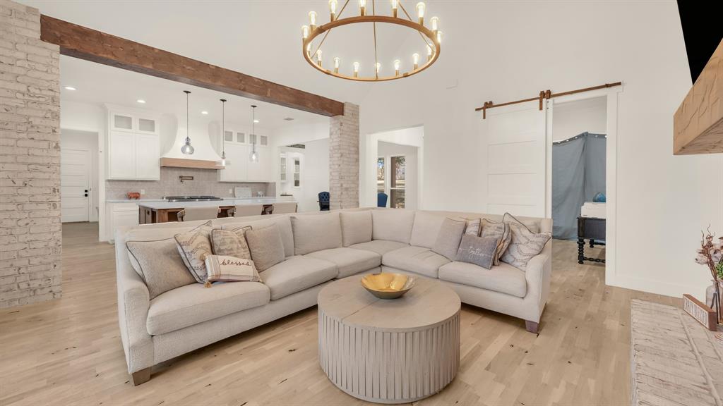374 Glade Valley Road Azle, TX 76020 - Photo 15 of 38 a living room with furniture a large window and a chandelier