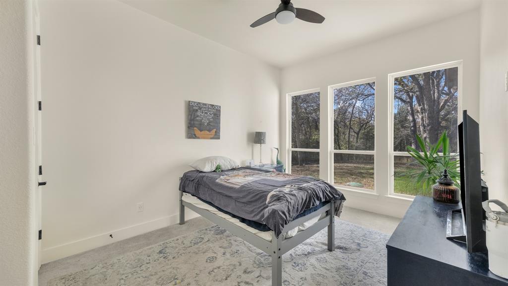 374 Glade Valley Road Azle, TX 76020 - Photo 21 of 38 a living room with a bed furniture and a large window
