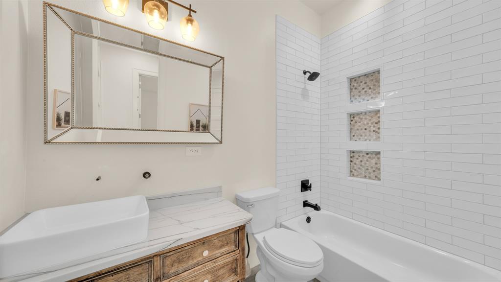 374 Glade Valley Road Azle, TX 76020 - Photo 25 of 38 a bathroom with a sink a toilet and shower