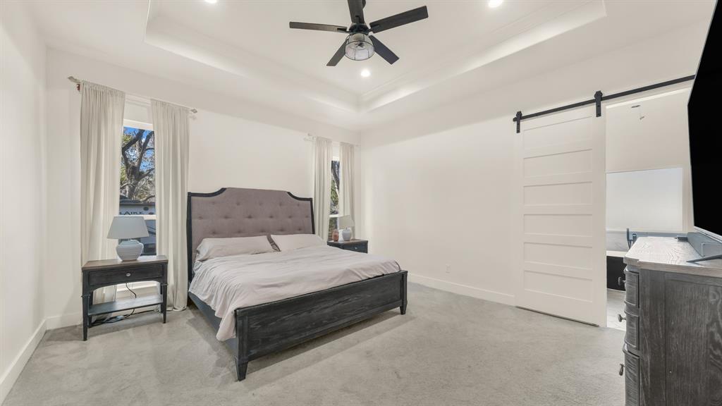 374 Glade Valley Road Azle, TX 76020 - Photo 26 of 38 a bedroom with a bed and a chandelier