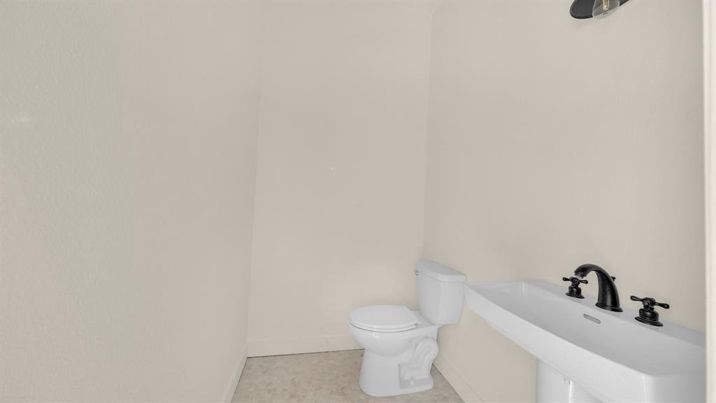 374 Glade Valley Road Azle, TX 76020 - Photo 33 of 38 a white toilet sitting next to a white sink