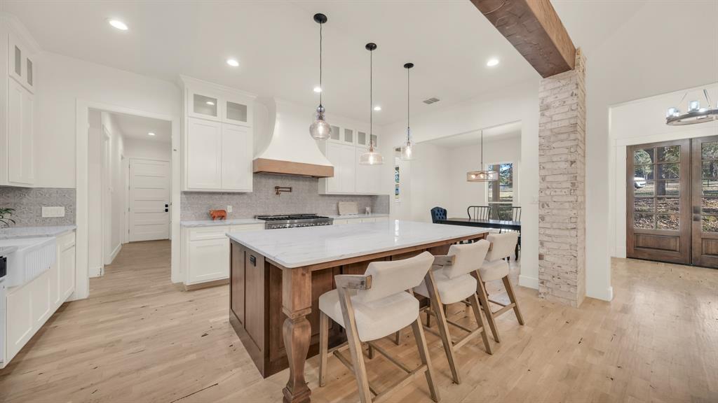 374 Glade Valley Road Azle, TX 76020 - Photo 6 of 38 a kitchen with stainless steel appliances kitchen island a refrigerator and a stove top oven