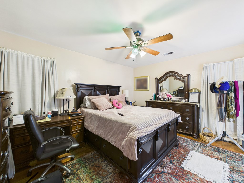 1608 39th Street Columbus, GA 31904 - Photo 17 of 63 a bedroom with a bed a large window and book self