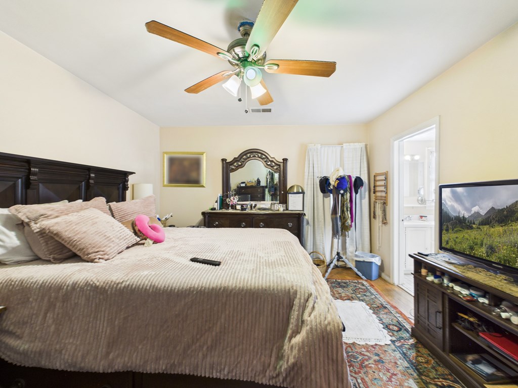 1608 39th Street Columbus, GA 31904 - Photo 18 of 63 a bedroom with a bed and a flat screen tv