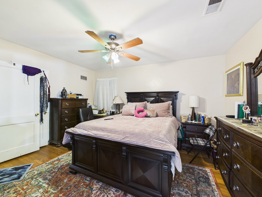 1608 39th Street Columbus, GA 31904 - Photo 19 of 63 a bedroom with a bed and a chandelier