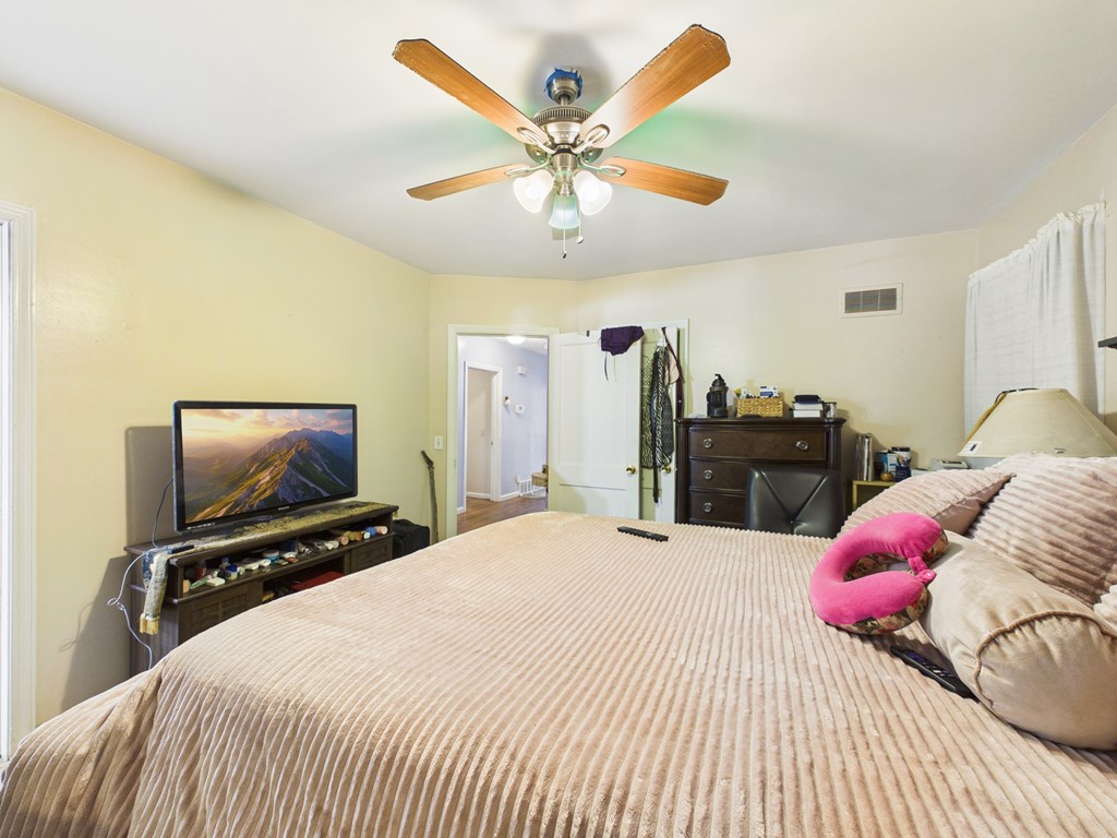 1608 39th Street Columbus, GA 31904 - Photo 20 of 63 a bedroom with a bed dresser and flat screen tv