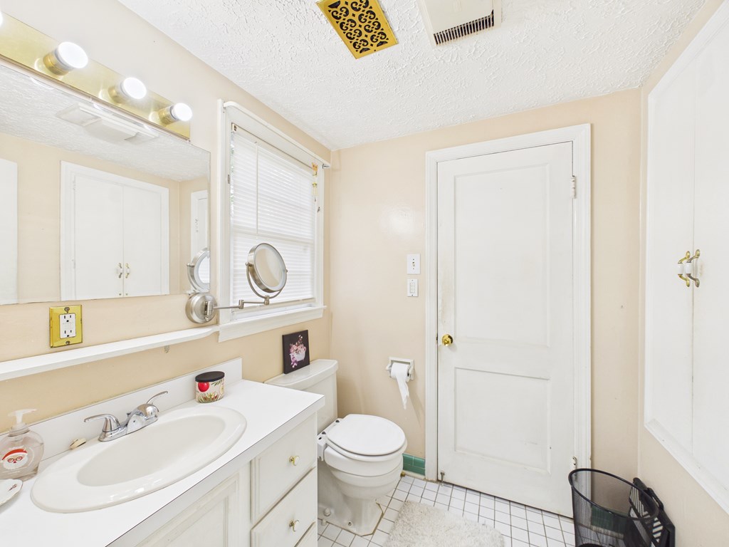 1608 39th Street Columbus, GA 31904 - Photo 21 of 63 a white toilet sitting next to a bathroom sink
