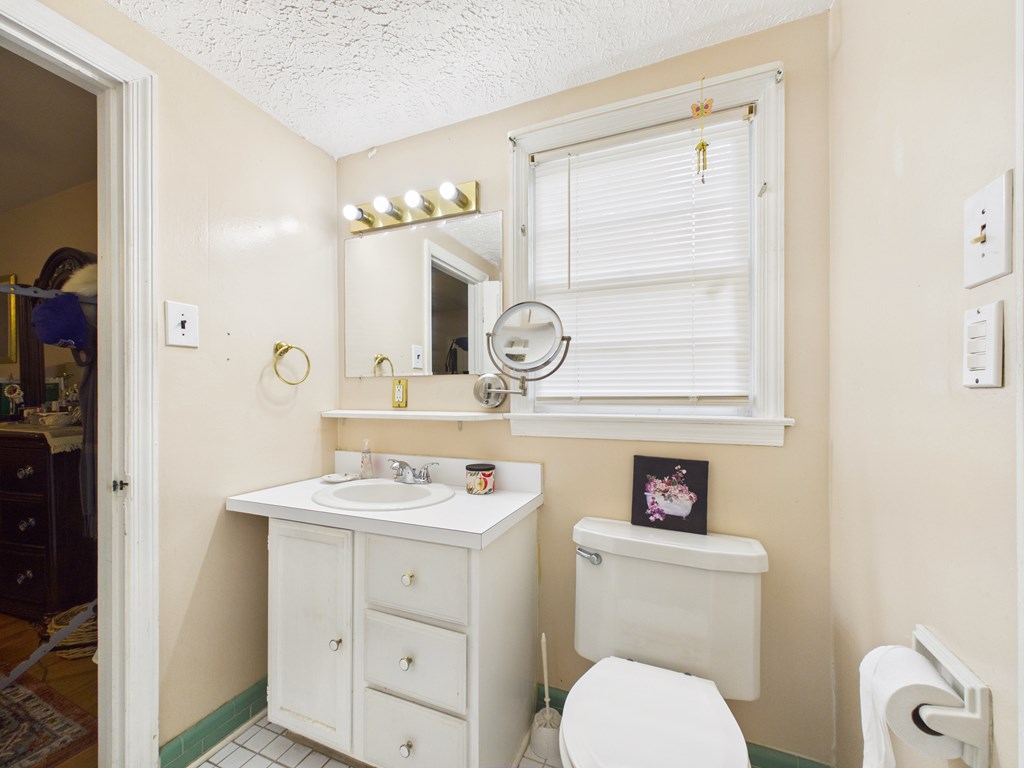 1608 39th Street Columbus, GA 31904 - Photo 22 of 63 a bathroom with a sink a toilet and a mirror