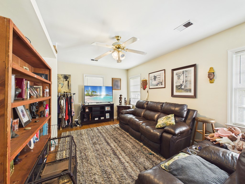 1608 39th Street Columbus, GA 31904 - Photo 25 of 63 a living room with furniture fireplace and a window