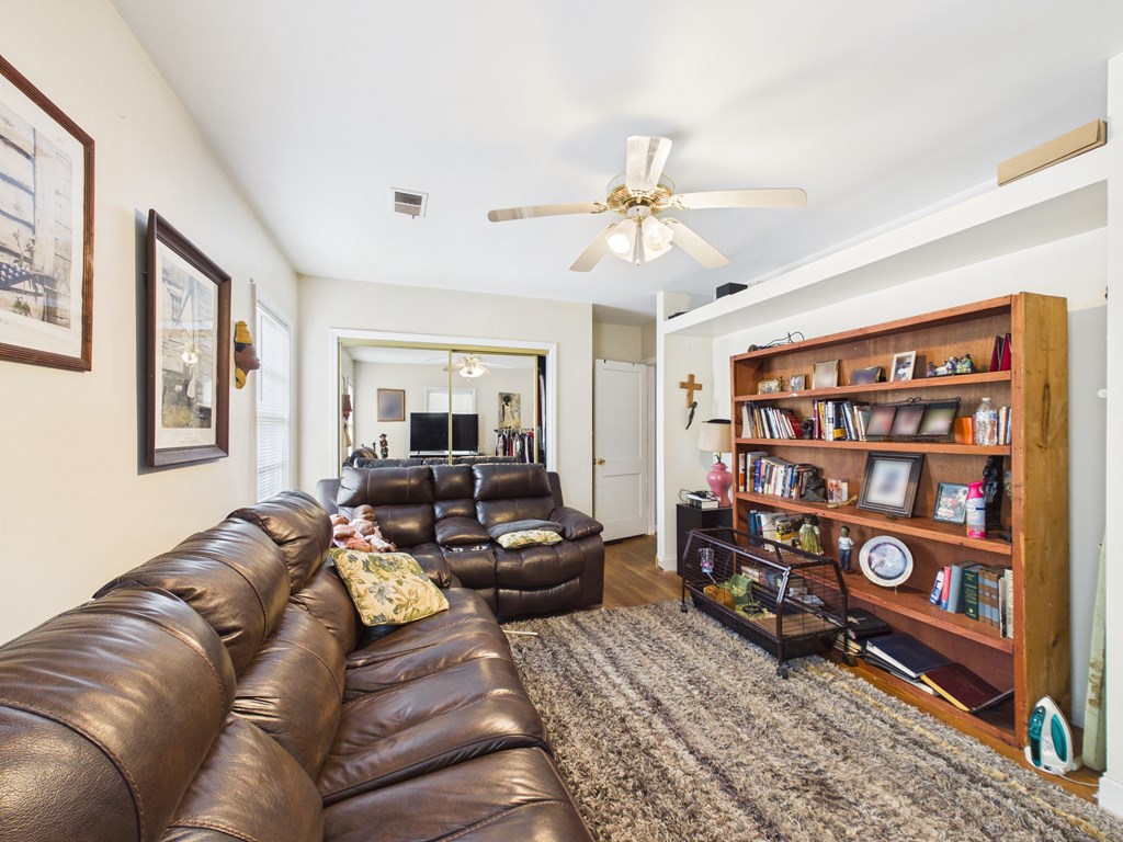 1608 39th Street Columbus, GA 31904 - Photo 27 of 63 a living room with furniture a bookshelf and a window