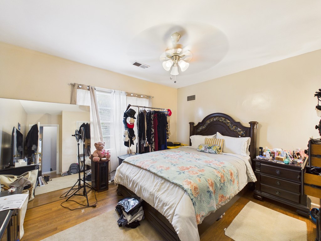 1608 39th Street Columbus, GA 31904 - Photo 28 of 63 a bedroom with bed and a chandelier