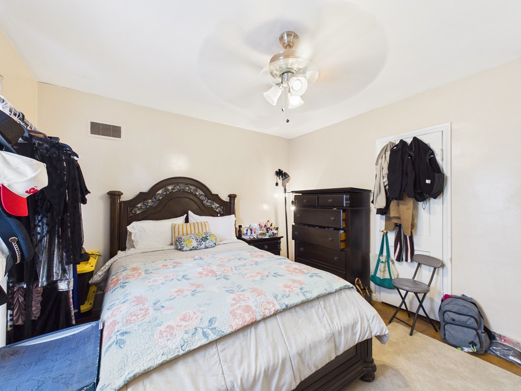1608 39th Street Columbus, GA 31904 - Photo 29 of 63 a bedroom with a bed and a chandelier