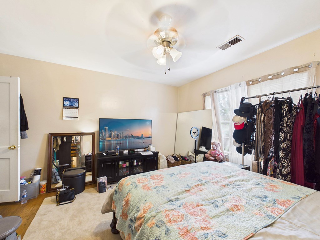 1608 39th Street Columbus, GA 31904 - Photo 30 of 63 a bed room with a bed and a mirror