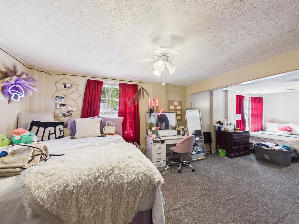 1608 39th Street Columbus, GA 31904 - Photo 31 of 63 a bed room with a bed furniture and a chandelier