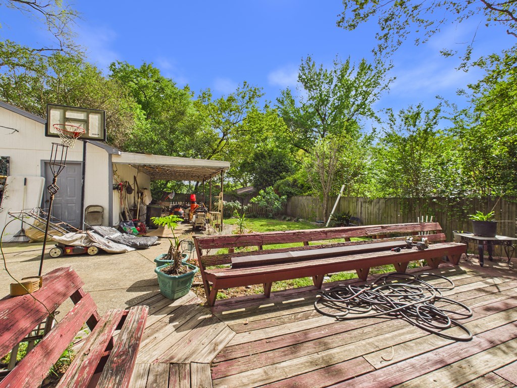 1608 39th Street Columbus, GA 31904 - Photo 56 of 63 a view of a patio with table and chairs potted plants and large tree