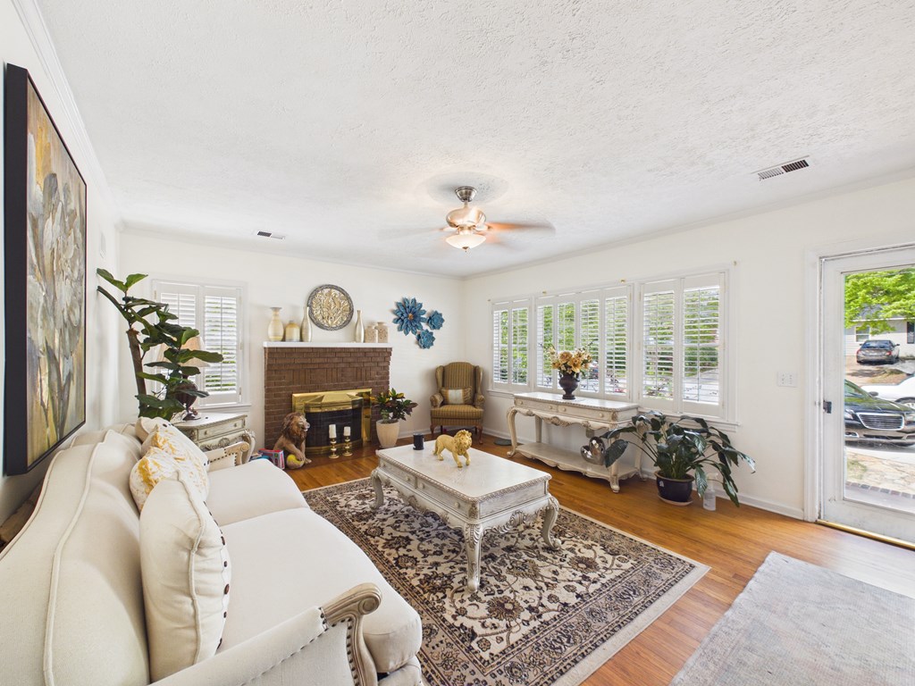 1608 39th Street Columbus, GA 31904 - Photo 7 of 63 a living room with furniture a fireplace and a table
