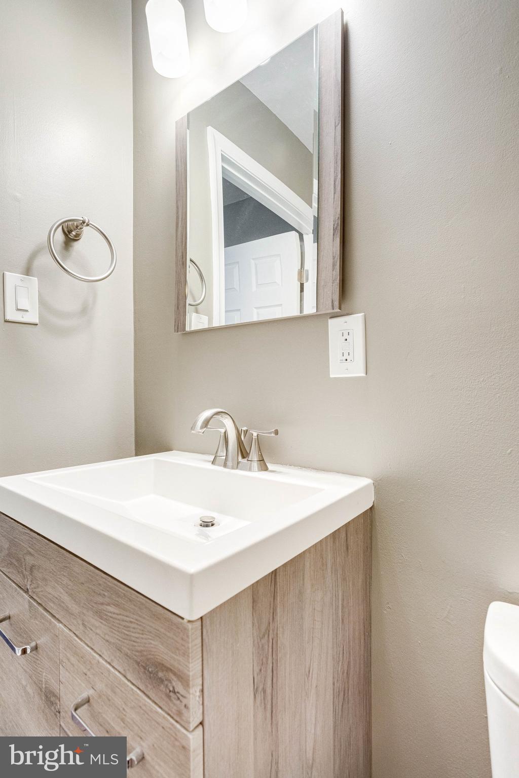 2648 Bowen Road Southeast Washington, DC 20020 - Photo 18 of 36 a bathroom with a sink vanity and a mirror