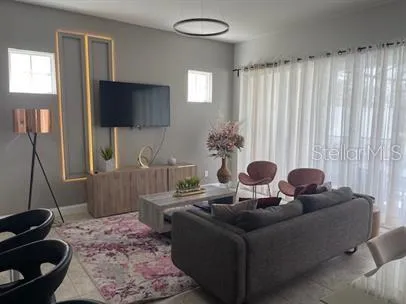 a living room with furniture and a flat screen tv